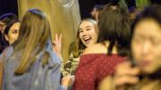 "One young adult is caught enthusiastically smiling at the camera, having the time of her life."